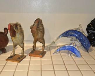 Leather weenie-dog bank, whimsical taxidermy frogs playing instruments, glass dolphins and a granite seal with ball