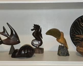 large selection of collectibles includes wood, glass flowers, and porcelain