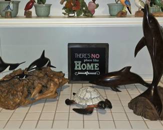 large selection of collectibles includes wood, glass flowers, and porcelain