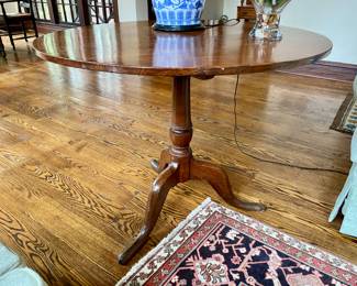 Oak tilt-top table 29"h x 36" diameter