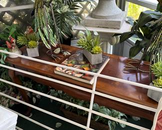 Metal peacocks sitting on a sofa table
