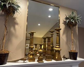 Square brass framed mirror, Pair of tall buffet topiaries, Set of 5 candle holders, and pair of plated peacocks