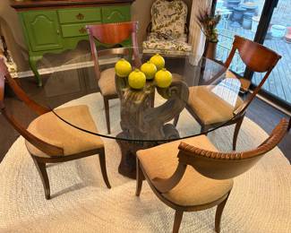 Glass topped round dining table with solid pedestal and 4 curved back dining chairs on Pottery Barn Jute round rug