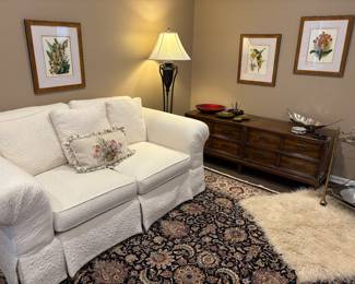2-cushion couch and long console cabinet - MCM, botanical prints, wool area rug, alpaca rug, and metal floor lamp