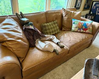 Distressed leather couch and wood bunny figurine
