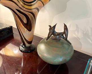 Urn with bronze birds and large blown glass vase
