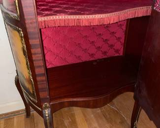 Antique Wooden Display Cabinet W/ Glass Door, Gold Metal Trim, Red Upholstered Interior, & Hand Painted Scene