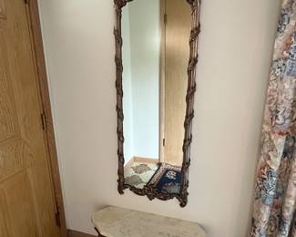 Gold framed wall mirror and marble table