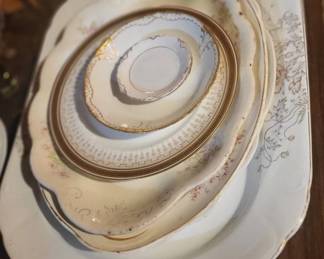 stack of platters, plates and butter pats