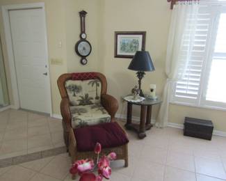 wicker chair with foot stool, lamps, wall art