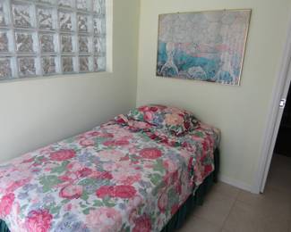 single bed, linens and art work