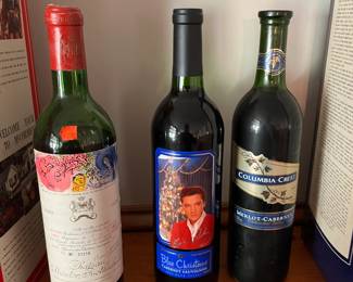 Collection includes 1970 ChΓ’teau Mouton Rothschild, Elvis βBlue Christmasβ Cabernet, and Columbia Crest Merlot-Cabernet. For display only.