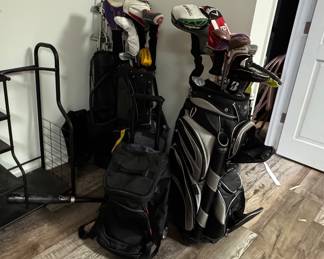 Various golf bags and used clubs