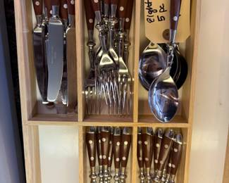 8 place settings of wood handled stainless flatware