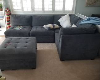 Contemporary gray sectional sofa with storage ottoman