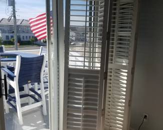 Plantation shutters for sliding glass doors