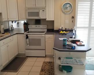 Crisp white kitchen with plenty of cabinets plus a pantry