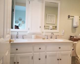 Double bath vanity by Quality Custom Cabinetry; vanity mirrors; vanity lights