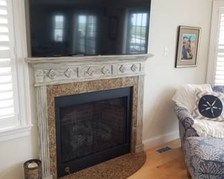 Flat screen TV with wall mount; fireplace mantel