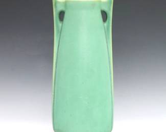 An early 20th century Teco Pottery vase designed by William Bryce Mundie. Shape #266, tapered buttressed form with matte Green glaze. Double impressed "Teco" marks. One buttress with professionally repaired tips and tiny flake, slight surface wear. 11" high.