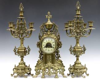 A turn of the century French three piece clock set. 8-day time and strike movement, porcelain dial with Roman numerals, serial #11607. Louis XVI style Bronze case and en suite with a pair of similar five light candelabra. Some wear, running when cataloged. Up to 22" high overall.