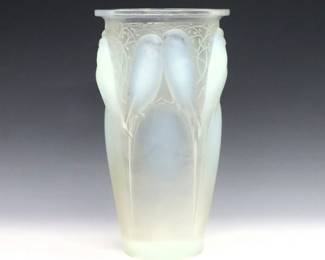 A 1920's Rene Lalique "Ceylan" glass vase. Opalescent glass with tapered form and molded songbird design. Wheel cut "R. Lalique France" mark and incised model "905". Minor surface wear, a few micro-flakes along edges of body. 9 1/2" high.