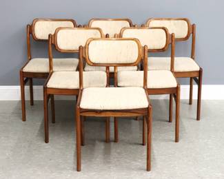A set of six Danish Modern dining chairs by Johannes Andersen for Uldum Mobelfabrik. Teak construction with upholstered backs and seats on tapered legs. Retain original "Uldum Mobelfabrik / Made in Denmark" labels at undersides. Original finish with minor wear, upholstery worn with some staining. 18 1/2 x 18 x 30" high overall.
