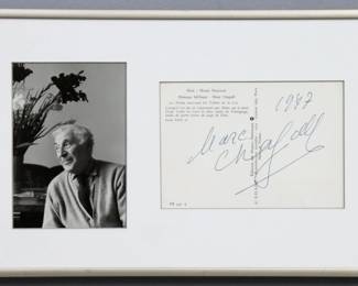 A 1970's gallery postcard signed by Marc Chagall, Russian/French, 1887-1985. Framed with a black and white photo of the artist. Postcard signed "Marc Chagall" and dated "1977". Minor toning. In a brushed metal frame with slight wear, 13 3/4 x 8 1/2" high overall.