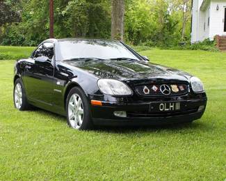 A 1998 Mercedes-Benz SLK-Class 230 Convertible. Two door with Black exterior and charcoal leather interior, 4 cylinder engine, 5 speed automatic transmission, odometer shows 29,319 miles. CONDITION: Previous accident history at rear, fully repaired with paperwork, slight wear to interior, minor scratches to exterior paint, starts and drives, not road tested. Retains original owner's manual, purchase paperwork and extensive service records up to 28,944 miles in 2024, includes two sets of keys.