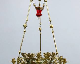 An early 20th century Brass chandelier. Brass body with fruit and floral design, painted Green accents and six scrolled candle holders. Electrified, canopy flipped for bulb, some wear. 37" high.