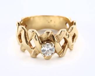 A vintage 14k Gold and Diamond ring. Features a round cut prong set solitaire diamond approx. 4 mm and estimate 0.25 ct, on a wide band with openwork design. Marks worn, tested 14k. 6.1 grams total. Minor surface wear, Diamond with micro chip at one facet. Size 8.