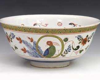 An 18th century Delft Earthenware bowl. Polychrome bird and floral decoration surrounded by geometric borders. Monogrammed "PK". Some crazing and surface wear, minor flakes. 10 3/4" diameter x 4 3/4" high.