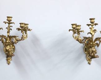 A pair of turn of the century French Louis XV style Bronze sconces. Five light design with scrolling foliate arms and cast Grape drop finials. Wear to patina, minor distortion. 14 1/2 " high.