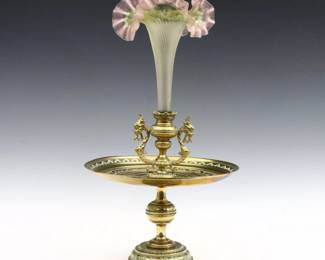 A late 19th century Victorian Period epergne. Art Glass trumpet vase with ruffled rim and threaded decoration over a Bronze base with cast foliate design. Minor wear to base, vase with chip where inserted into base. 10" diameter x 18" high overall.