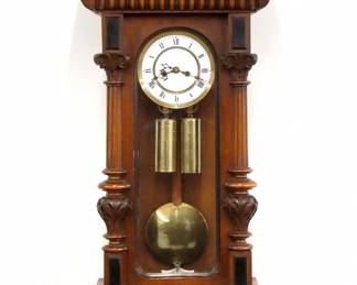 A 19th century Vienna Regulator wall clock by The Resch Brothers, Ebensee, Austria. 8-day weight driven time and strike movement with two-part porcelain dial with Roman numerals within a molded Brass bezel, serial #54498. Altdeutsch style Walnut case features a shaped crest over an arched door flanked by turned fluted pilasters with carved detail and shaped lower bracket. Older finish with minor wear, dial hairlines, not running when cataloged. 37" high overall.