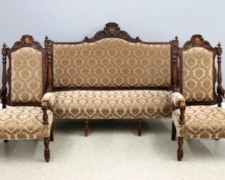 A three piece 19th century Victorian Renaissance Revival Period parlor set. Beech construction with carved crests over upholstered backs and seats with open arms and carved legs. Older, dark finish with some wear, minor damage. Settee is 66 1/2 x 24 x 48" high overall, chairs are 24 1/2 x 24 x 44" high overall.