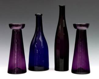 Four pieces of mid 19th century American glass. Includes a pair of free blown Amethyst hyacinth vases, a free blown and cut Cobalt bottle, and a pattern molded Amethyst bottle. Amethyst bottle with chips to rim, minor surface wear. Up to 11 1/4" high.