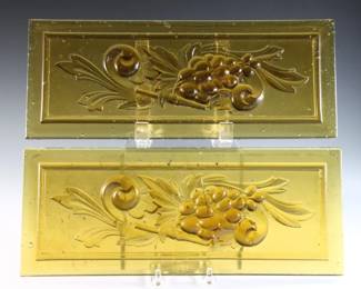 A pair of turn of the century American pressed Amber glass window panes with Grape Vine design. Some small flakes along edges. Each 12 1/2 x 5" high overall.
