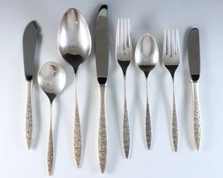 Sixty-six pieces of Wallace "Spanish Lace" pattern Sterling Silver flatware. Features 9 complete five-piece place settings plus additional flatware and serving utensils. Includes 12 x 9 1/8" hollow handle dinner knives, 12 x 6 5/8" hollow handle butter knives, 3 x 7" hollow handle master butter knives, 14 x 7 5/8" dinner forks, 9 x 6 5/8" salad forks, 11 x 6 1/4" teaspoons, 2 x 6 1/8" soup spoons and 1 x 8 1/2" serving spoon. Stamped "Wallace Sterling" and "Spanish Lace" marks. 45.43 troy ozs plus 29 hollow handles, approx. 61.41 total. Some surface wear.