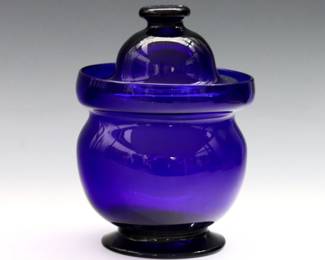 An early 19th century American free blown covered sugar. Cobalt Blue glass with bulbous form, galleried rim and high domed cover. Chip to bowl rim, minor surface wear and fleabites. 6" high.