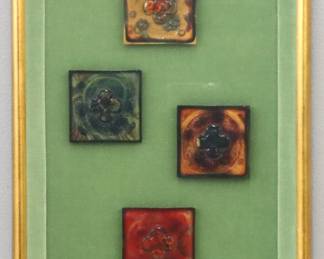 Four framed turn of the century Tiffany Glass tiles. Each with a multicolor quatrefoil design. Retains a "Birmingham Gallery Inc." label verso. Tiles with some flakes along edges, one with short hairline, not examined out of frame. Tiles approx. 3 x 3" high, in a Gilded shadowbox frame, 12 1/2 x 18 1/2" high overall.