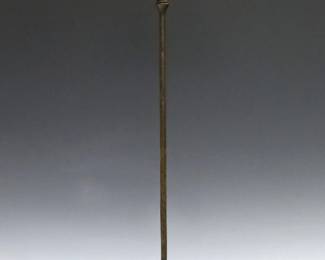 A turn of the century Tiffany Bronze and Favrile Glass candlestick. Floriform with Green glass detail, slender stem and a patinated finish. Impressed "T & Co." mark with "S1571" at underside. Minor wear, lacks original bobeche. 17 1/2" high overall.