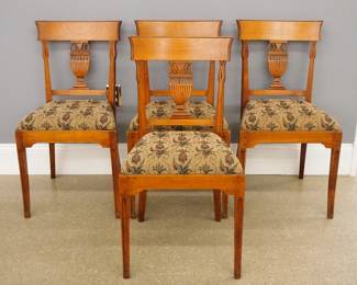 Four late 18th century French Louis XVI dining chairs. Cherry mortise and tenon, pegged construction with hand carved detail features shaped, molded backs with carved urn splats, over upholstered seats on rails with bracket corners, Sabre legs with inset panels. Refinished with slight wear, minor restoration and reupholstered seats. Each 34 1/2" high.
