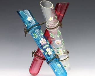 A turn of the century Legras glass triple bud vase. Shape #2851, three tube form vases in Cranberry, Blue and clear glass with enameled floral decoration and twisted "rope" frame. Featured in the Legras et Cie 1899 catalog. Minor surface wear and fleabites. 9" high.