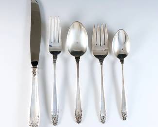 Forty pieces of International "Prelude" pattern Sterling Silver flatware. Features 8 five-piece place settings. Includes 8 x 9 1/4" hollow handle dinner knives, 8 x 7 1/4" dinner forks, 8 x 6 1/2" salad forks, and 8 x 6" teaspoons. Stamped "International Sterling" and "Prelude" marks. 40.45 troy ozs plus 8 hollow handles, approx. 44.45 total. Minor surface wear.