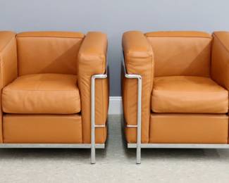 A pair of contemporary Le Corbusier for Cassina LC2 club chairs. Chrome tube frames with camel color leather upholstery. Originally designed in 1928 by Le Corbusier, Pierre Jeanneret and Charlotte Perriand. Engraved "Cassina LC2 / Le Corbusier / Made in Italy" at underside of arms, branded "Cassina" fabric at underside of seat. Slight wear. Each 30 x 27 x 27" high overall.