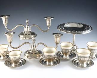 Fifteen pieces of American Sterling Silver. Includes a pair of Watson weighted candelabras, a Wallace compote, and six Sterling demitasse cups and saucers with Lenox porcelain liners. Each marked "Sterling". 17.55 troy ozs total, un-weighted Sterling only. Some surface wear. Up to 5 1/4" high.