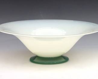 An early 20th century Steuben Art Glass center bowl. Calcite bowl with flared form and a Jade Green circular foot. Minor surface wear. 10" diameter x 3 1/2" high overall.