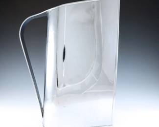 A 1930's Peter Muller-Munk "Normandie" pitcher for Revere Copper and Brass, Inc. Art Deco design with Chrome plated Brass body. Marked "Revere / Rome / NY" at underside. Some surface wear and light scratches, some oxidation to interior. 12" high.
