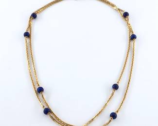 A 14k Gold and Lapis Lazuli necklace. Features nine Lapis Lazuli beads on a squared cable chain. Double marked "14k" at clasp. 26.0 grams total. Minor wear. 37" long open.